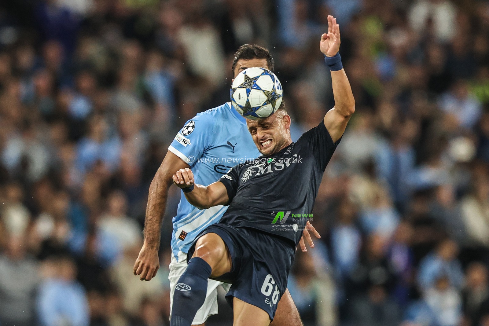 Rodrigo of Manchester City and Stanislav Lobotka of Napoli battle for the ball during the UEFA Champions League 2025/26 Phase MD1 Manchester City vs Napoli League at The City of Manchester Stadium, Manchester, United Kingdom, 18th September 2025

(Photo by Alfie Cosgrove/News Images)