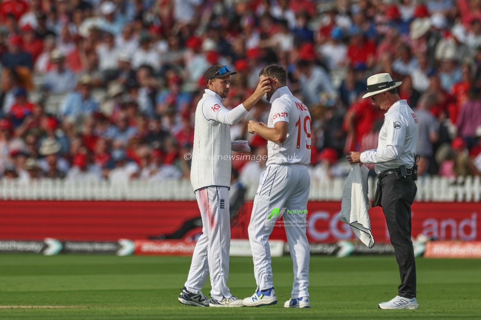 Joe Root of England wipes the ball down Chris Woakes of Englandâ€™s cheek during the Rothesay Test Match Day Two England v West Indies at Lords, London, United Kingdom, 11th July 2024

(Photo by Mark Cosgrove/News Images)