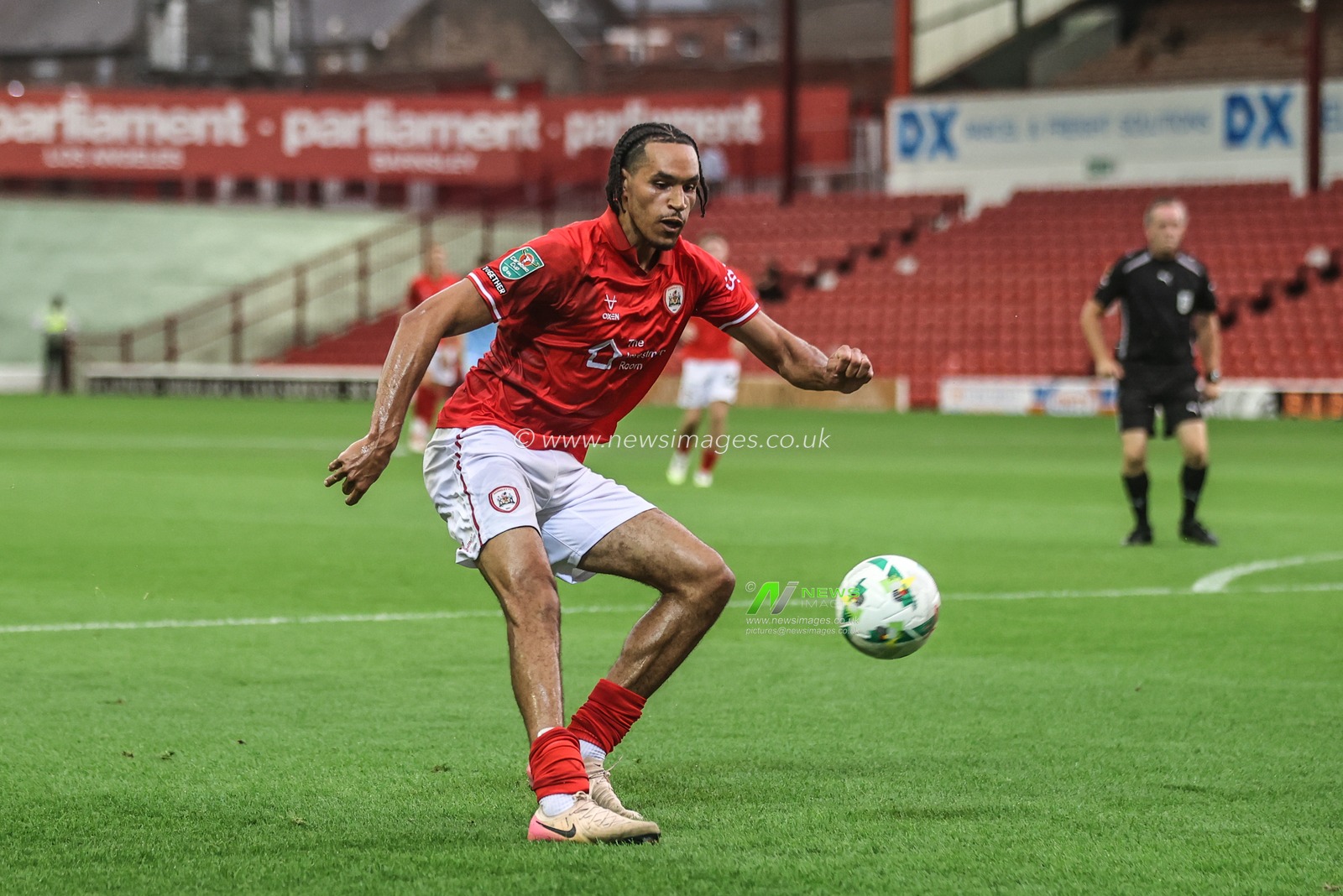 Jon Russell of Barnsley crosses the ball into the box during the Carabao Cup match Barnsley vs Fleetwood Town at Oakwell, Barnsley, United Kingdom, 13th August 2025

(Photo by Alfie Cosgrove/News Images)