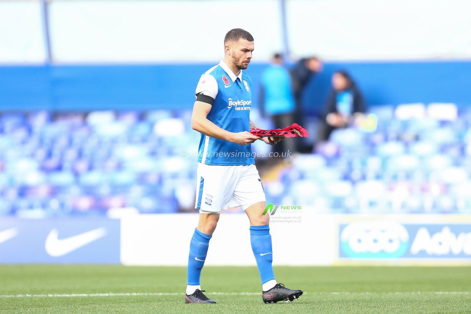 Harlee Dean #12 of Birmingham City carries a wreath