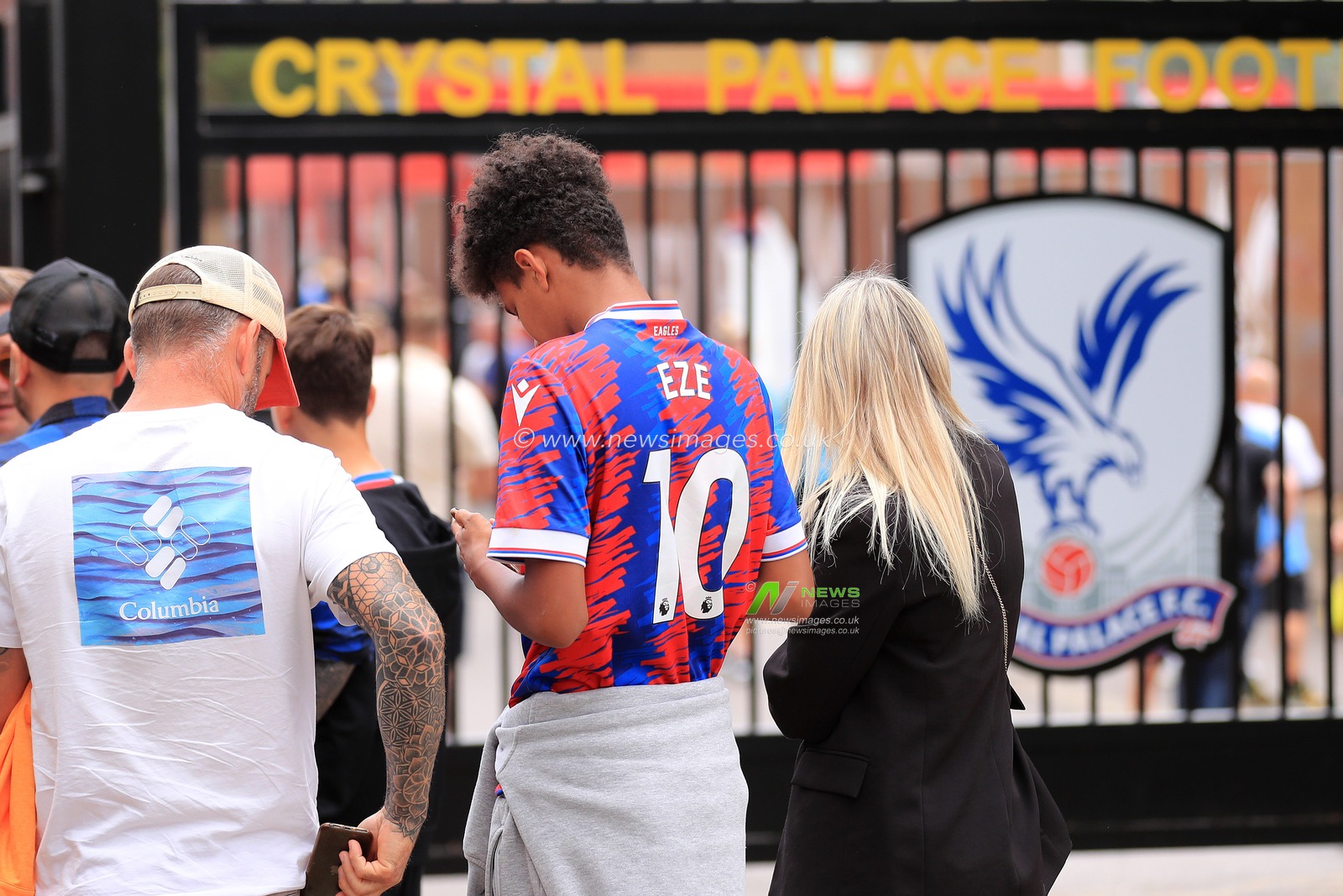 A Crystal Palace fan with Eberechi Ezeâ€™s name on his shirt, waits to collect his ticket.