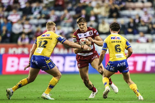 Harvey Makin of Wigan Warriors is tackled by James McDonnell of Leeds Rhinos and Brodie Croft of Leeds Rhinos during the Betfred Super League round 27 match Wigan Warriors vs Leeds Rhinos at The Brick Community Stadium, Wigan, United Kingdom, 19th September 2025

(Photo by Alfie Cosgrove/News Images)