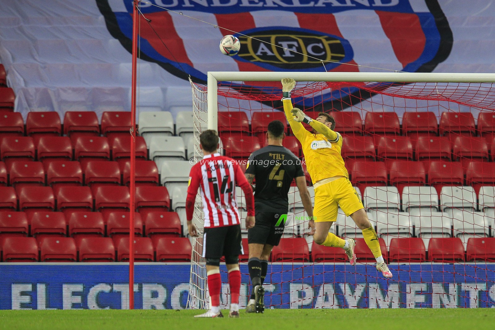 Jamie Jones #1 of Wigan Athletic palms the ball over the crossbar