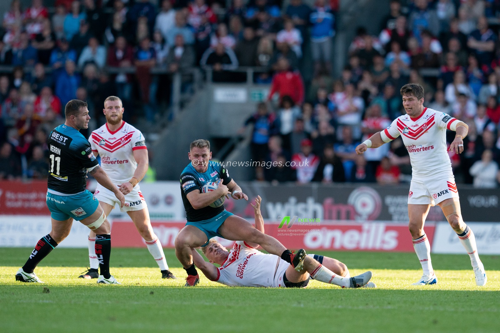 Leeds Rhinos's Bradley Dwyer is tackled by St. Helens's Aaron Smith


21st June 2019 , Totally Wicked Stadium, St Helens, England;  Betfred Super League, Round 19, St Helens vs Leeds Rhinos ; 


Credit: Terry Donnelly/News Images