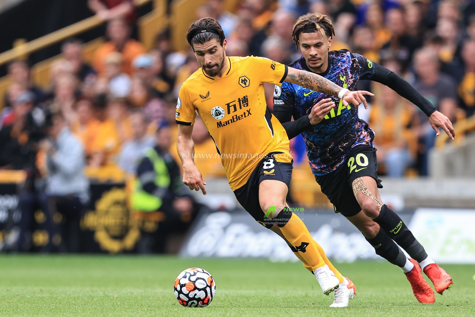 Ruben Neves #8 of Wolverhampton Wanderers breaks away from Dele Alli #20 of Tottenham Hotspur