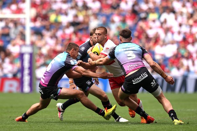 Mikey Lewis of Hull KR is tackled by 	Jake Arthur of Hull FC and Davy Litten of Hull FC during the Betfred Super League Magic Weekend match Hull KR vs Hull FC at Hill Dickinson Stadium, Liverpool, United Kingdom on 04 July 2026

(Photo by Alfie Cosgrove/News Images)
