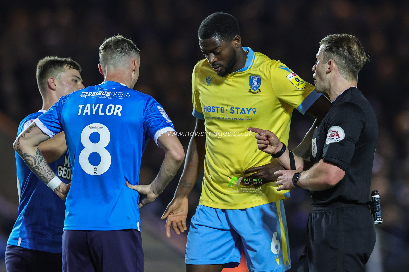 Referee Anthony Backhouse speaks to Jack Taylor #8 of Peterborough United and Dominic Iorfa #6 of Sheffield Wednesday during the Sky Bet League 1 Play-Offs match Peterborough vs Sheffield Wednesday at Weston Homes Stadium, Peterborough, United Kingdom, 12th May 2023

(Photo by Mark Cosgrove/News Images)