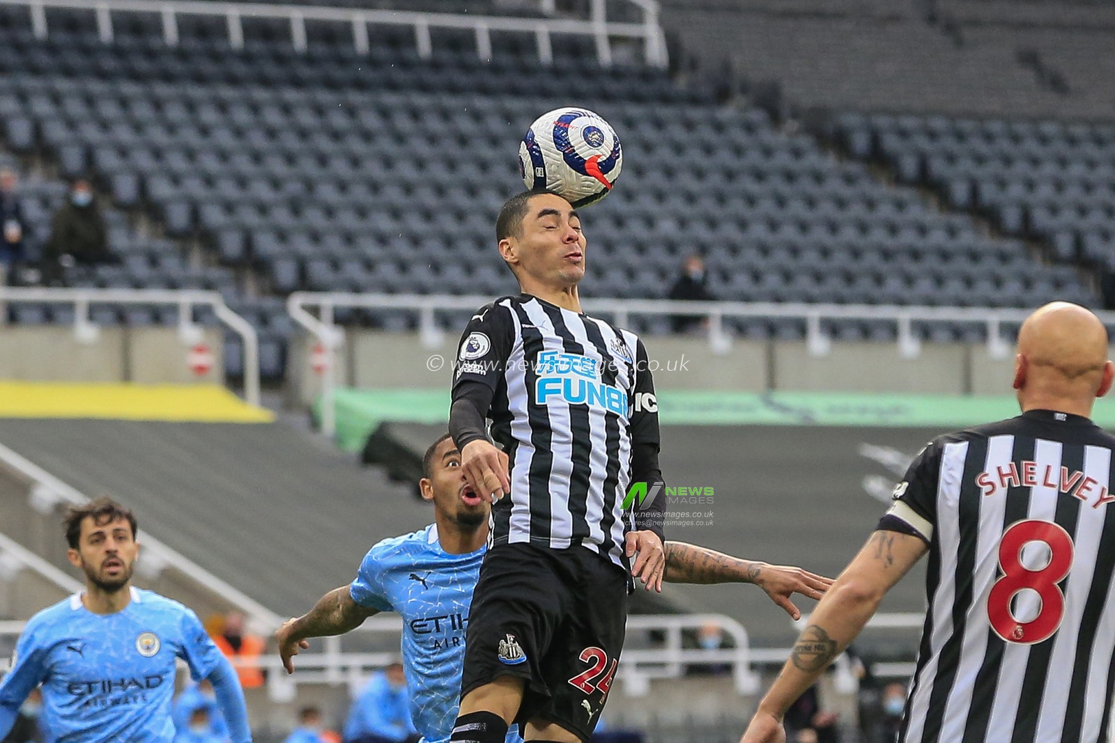 Miguel AlmirÃ³n #24 of Newcastle United heads the ball clear of the Newcastle United penalty area