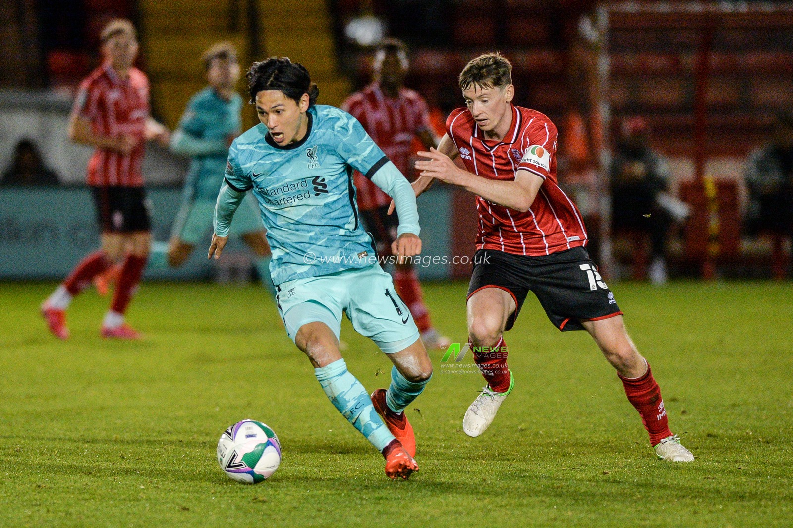 Takumi Minamino (18) of Liverpool in action.