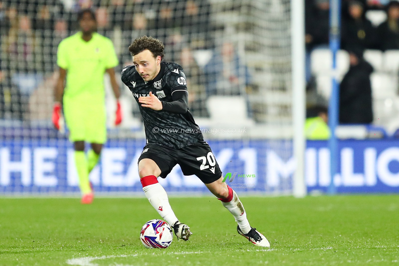 Ollie Rathbone of Wrexham passes the ball forward during the Sky Bet League 1 match Huddersfield Town vs Wrexham at John Smith's Stadium, Huddersfield, United Kingdom, 4th March 2025

(Photo by Jorge Horsted/News Images)