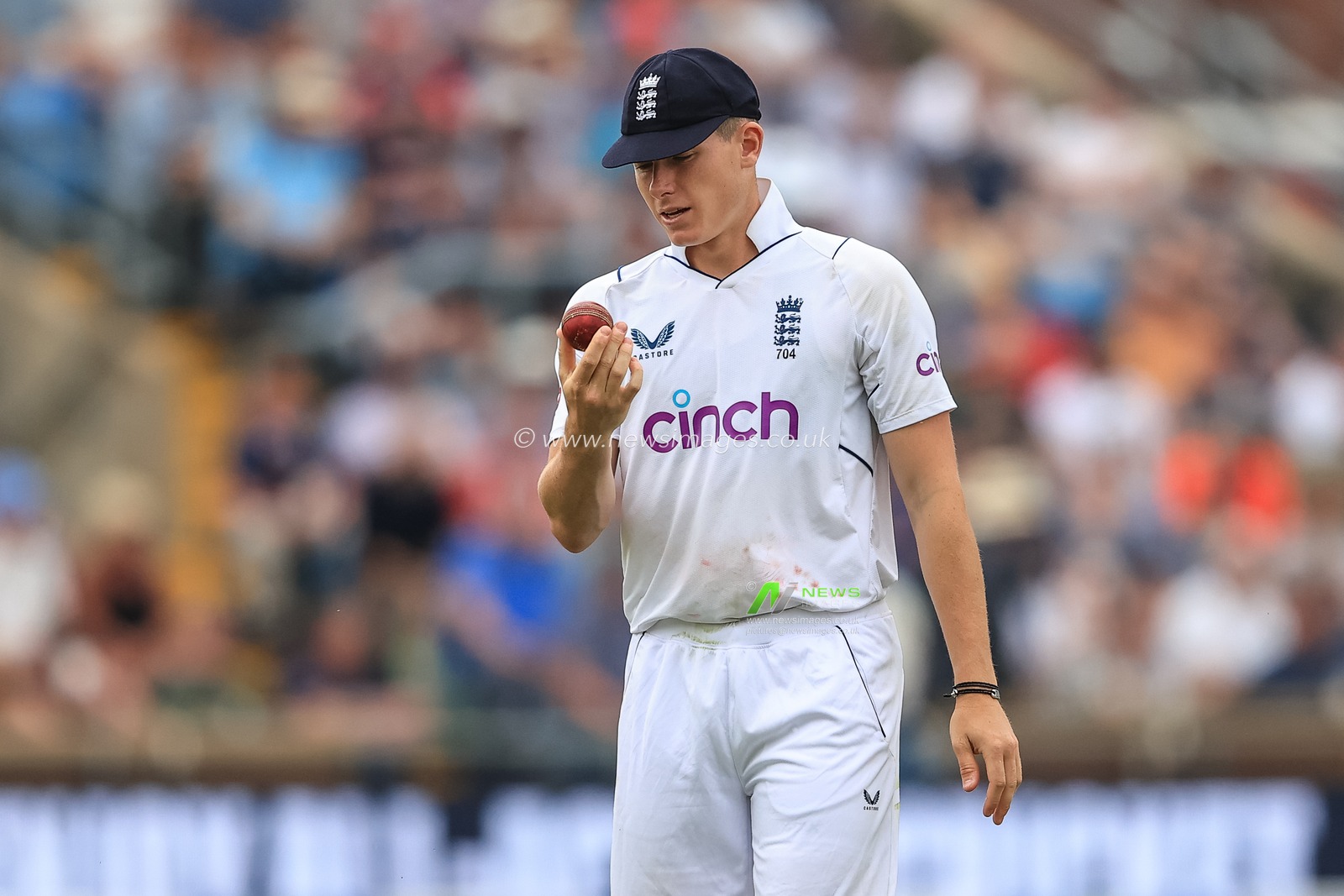 Matthew Potts of England inspects the ball