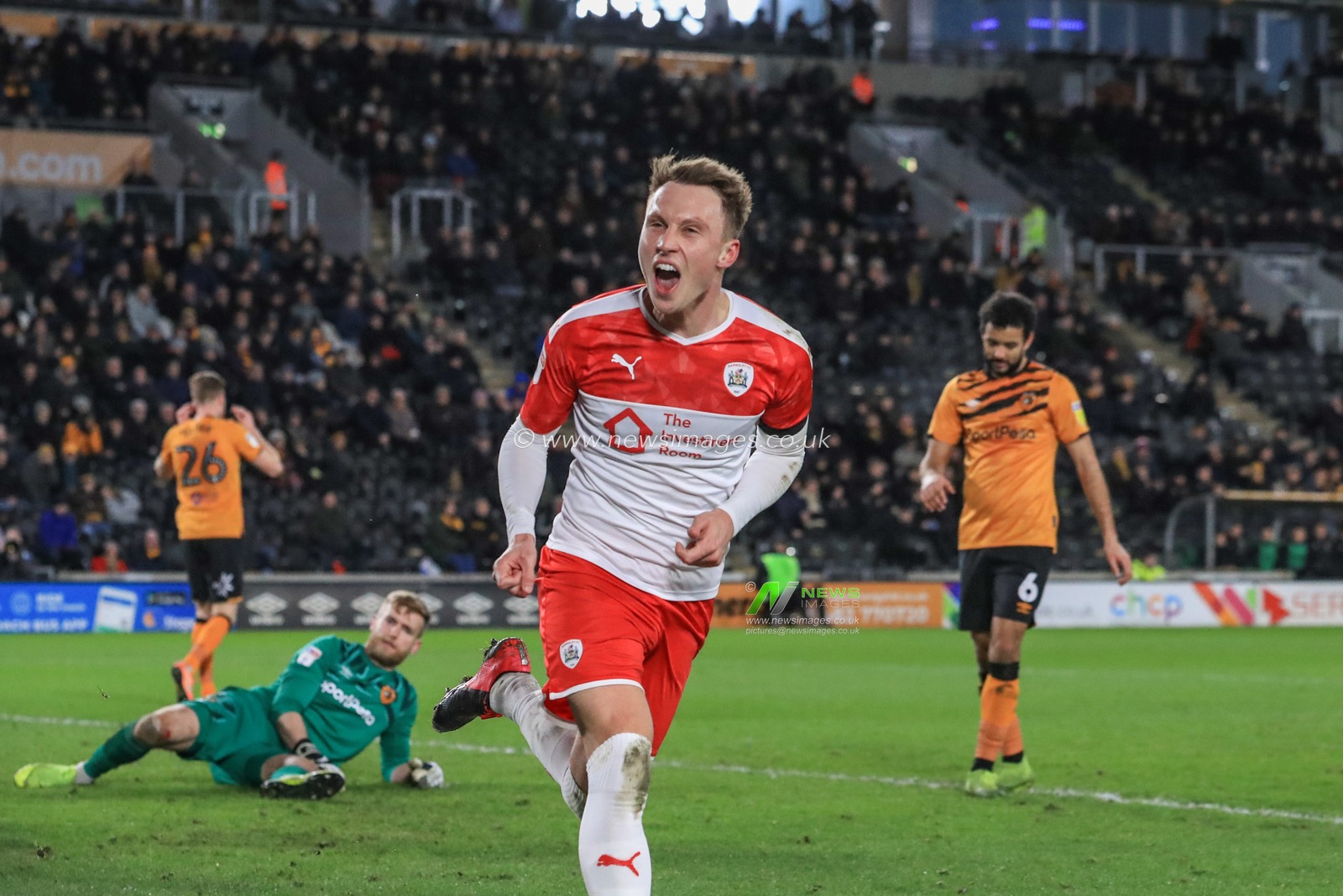26th February 2020, KC Stadium, Kingston upon Hull, England; Sky Bet Championship, Hull City v Barnsley : Cauley Woodrow (9) of Barnsley celebrates his goal to make it 0-1