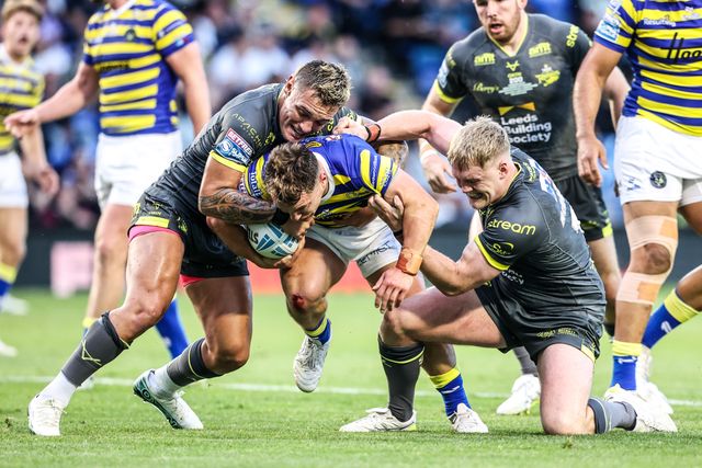 Leon Hayes of Warrington Wolves is tackled by James McDonnell of Leeds Rhinos during the Betfred Super League round 15 match Warrington Wolves vs Leeds Rhinos at The Halliwell Jones Stadium, Warrington, United Kingdom on 18 June 2026

(Photo by Alfie Cosgrove/News Images)