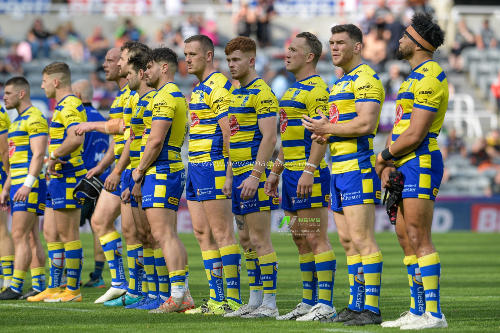The Warrington Wolves players line up before the game