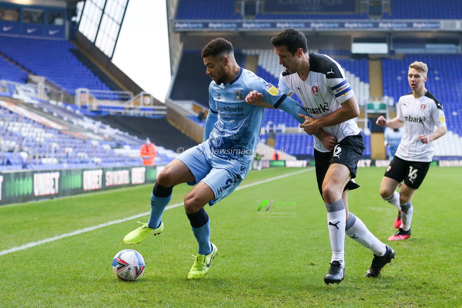 Maxime Biamou #9 of Coventry City holds off Richard Wood #6 of Rotherham United