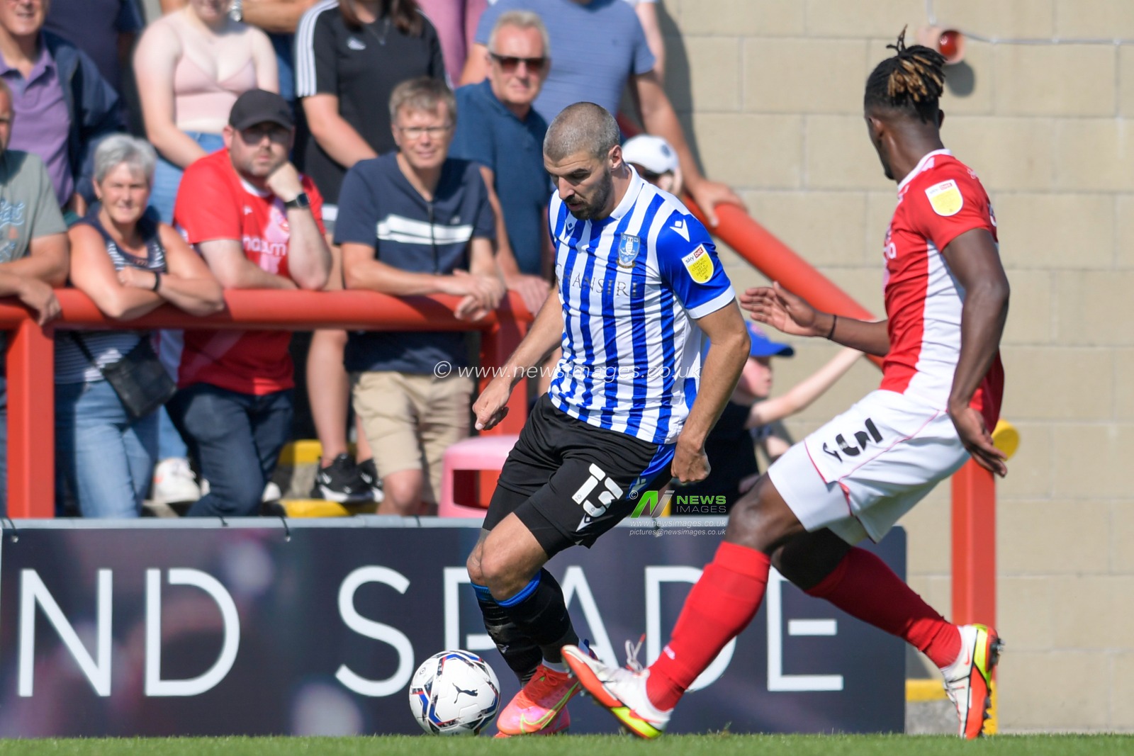 Callum Paterson #13 of Sheffield Wednesday looks for a way past Greg Leigh #3 of Morecambe