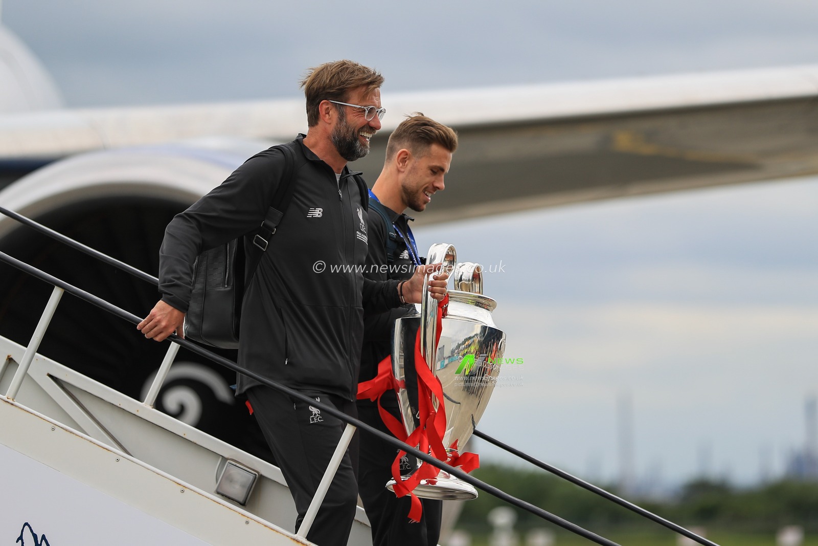 2nd June 2019 , Liverpool, England; UEFA Champions League, Liverpool FC Champions League winners celebrations and open top bus parade ; Liverpool manager Jurgen Klopp and Jordan Henderson leave the aeroplane carrying the European Cup


Credit: Mark Cosgrove/News Images