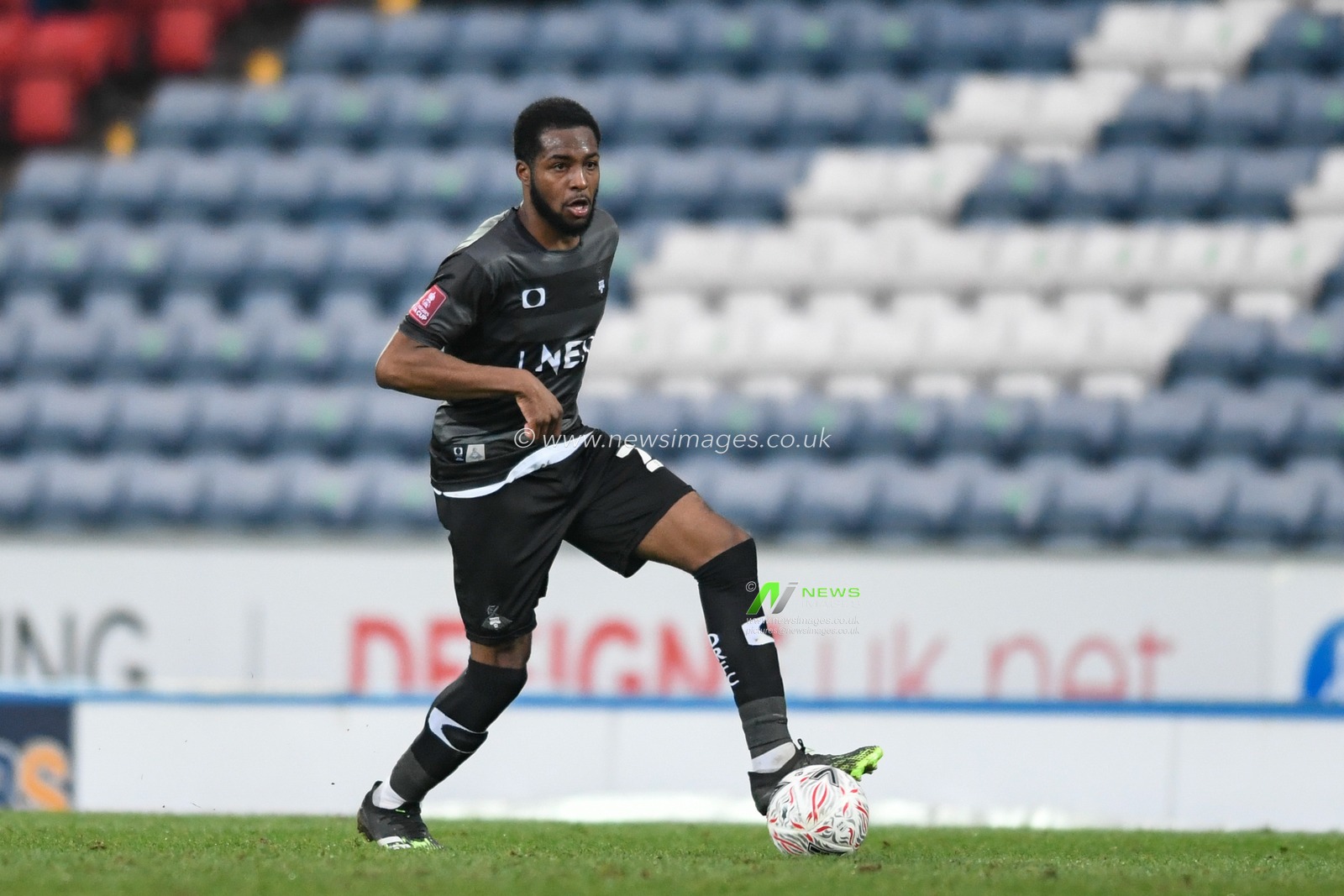Cameron John #24 of Doncaster Rovers runs forward with the ball