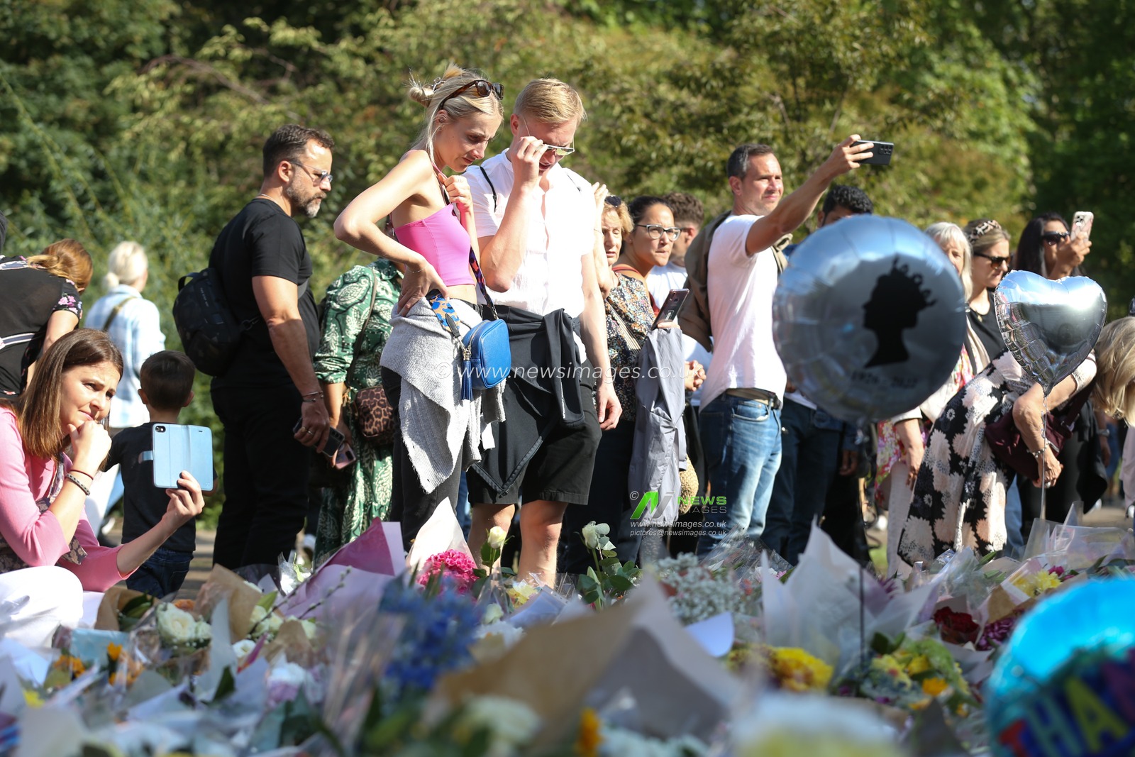 Mourners viewing the floral tributes as they pay their respects on day 3 after the passing of Her Majesty The Queen at Buckingham Palace, London, United Kingdom, 11th September 2022

(Photo by Arron Gent/News Images)