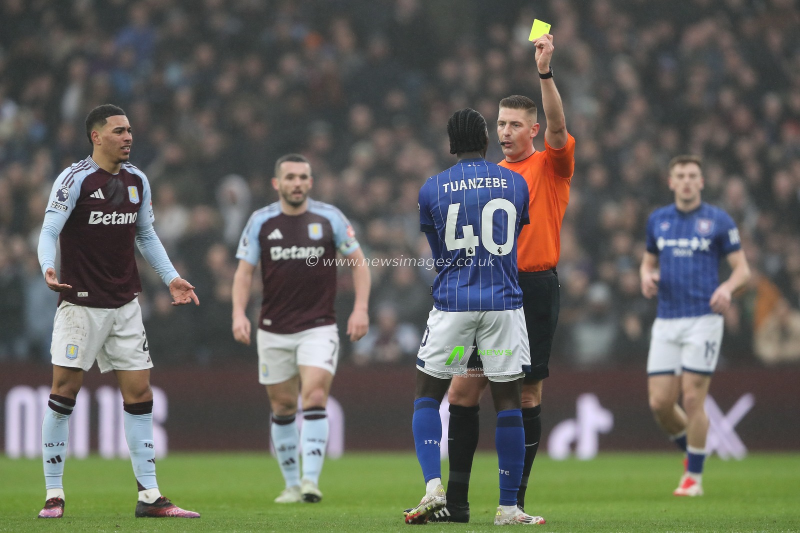 Axel Tuanzebe of Ipswich Town is shown a yellow card by referee Rob Jones after a foul on Morgan Rogers of Aston Villa during the Premier League match Aston Villa vs Ipswich Town at Villa Park, Birmingham, United Kingdom, 15th February 2025

(Photo by Gareth Evans/News Images)