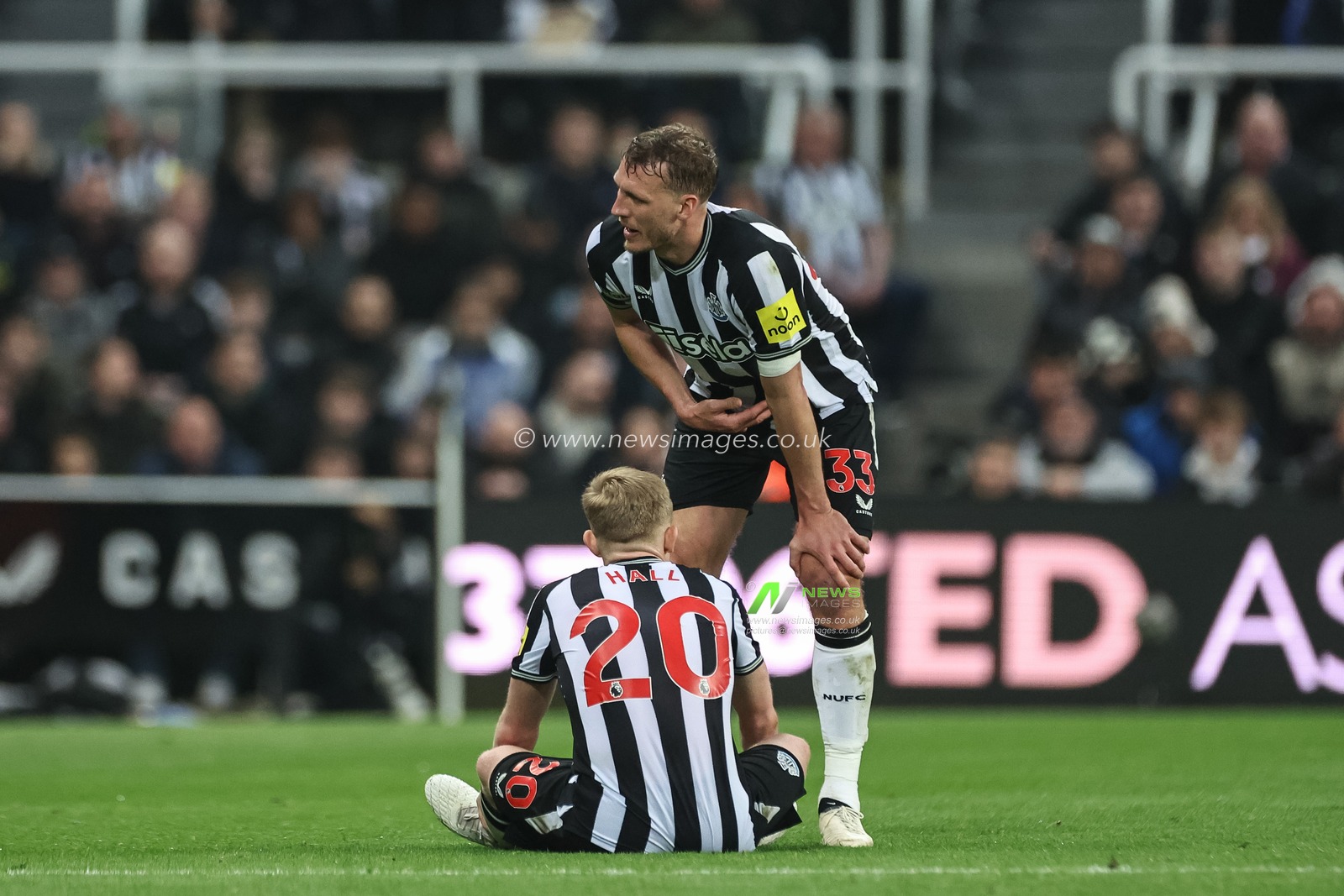 Dan Burn of Newcastle United checks on an injured Lewis Hall of Newcastle United during the Premier League match Newcastle United vs Everton at St. James's Park, Newcastle, United Kingdom, 2nd April 2024

(Photo by Mark Cosgrove/News Images)