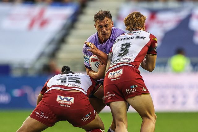 Jai Whitbread of Hull KR is tackled by Patrick Mago of Wigan Warriors and Adam Keighran of Wigan Warriors during the Betfred Super League round 22 match Wigan Warriors vs Hull KR at The Brick Community Stadium, Wigan, United Kingdom, 15th August 2025

(Photo by Alfie Cosgrove/News Images)