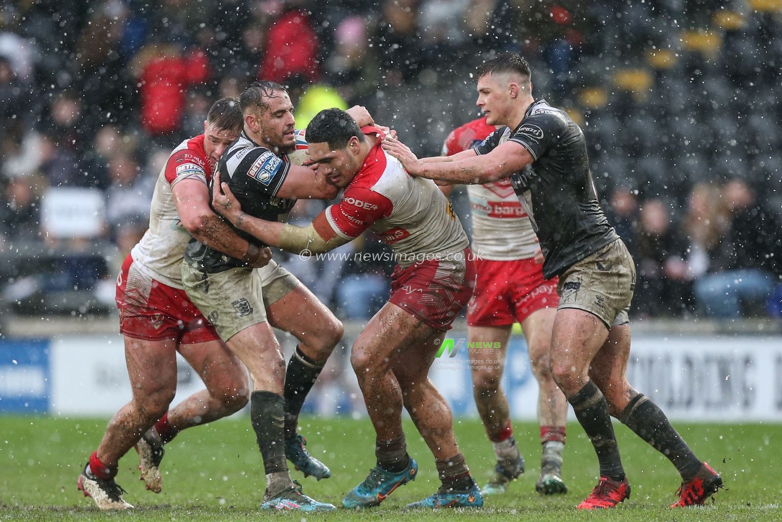 Josh Reynolds (6) of Hull FC is wrapped up by the St Helens defence