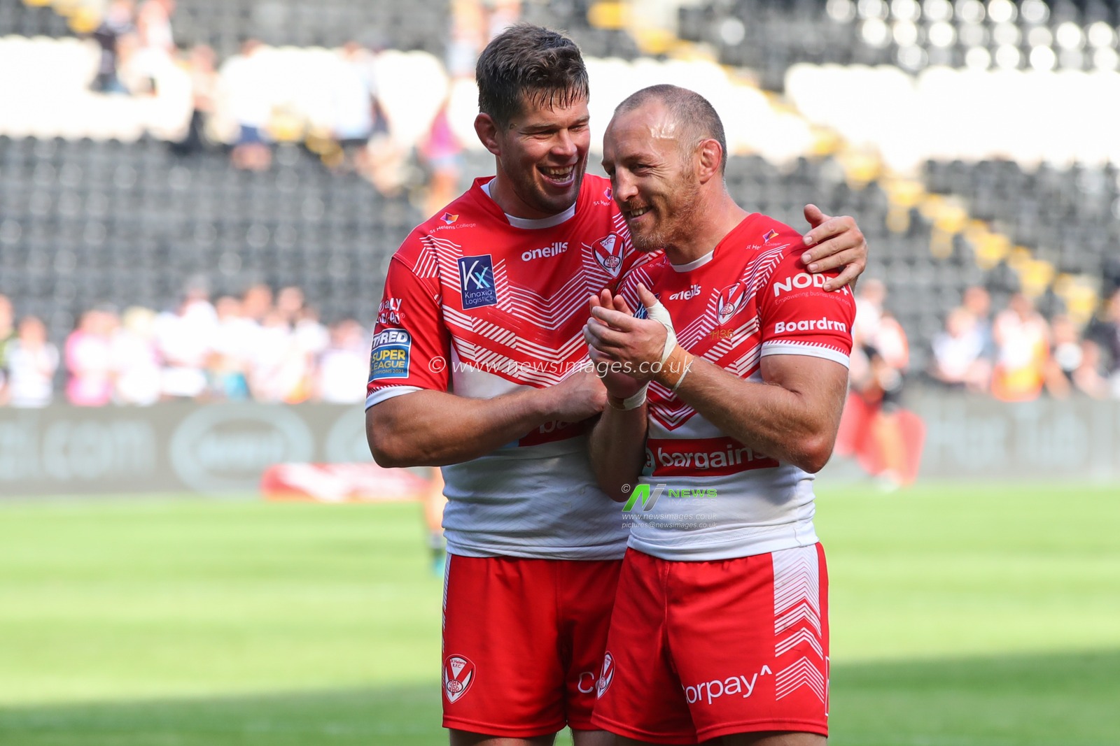 Louie McCarthy-Scarsbrook #15 and James Roby #9 of St Helens share a joke after the final whistle