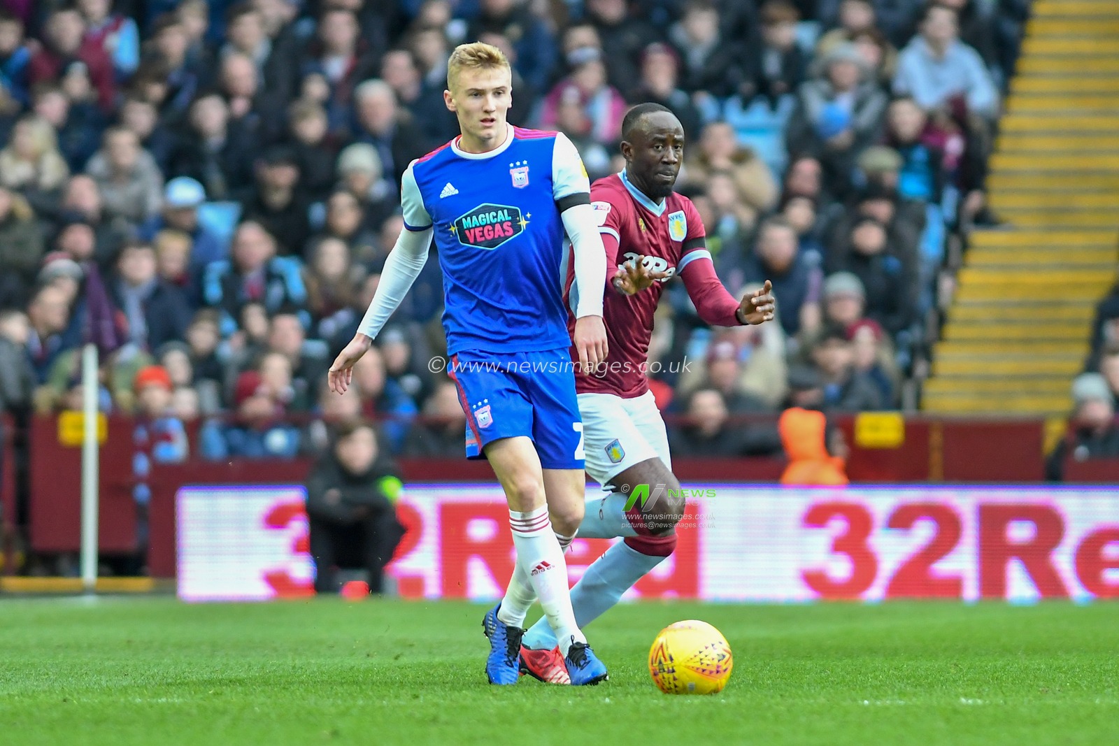 26th January, Villa Park, Birmingham, England ; Sky Bet Championship, Aston Villa vs Ipswich Town : Flynn Downes (21) of Ipswich Town passes the ball under pressure from Albert Adomah (37) of Aston Villa

Credit: Gareth Dalley/News Images

English Football League images are subject to DataCo Licence