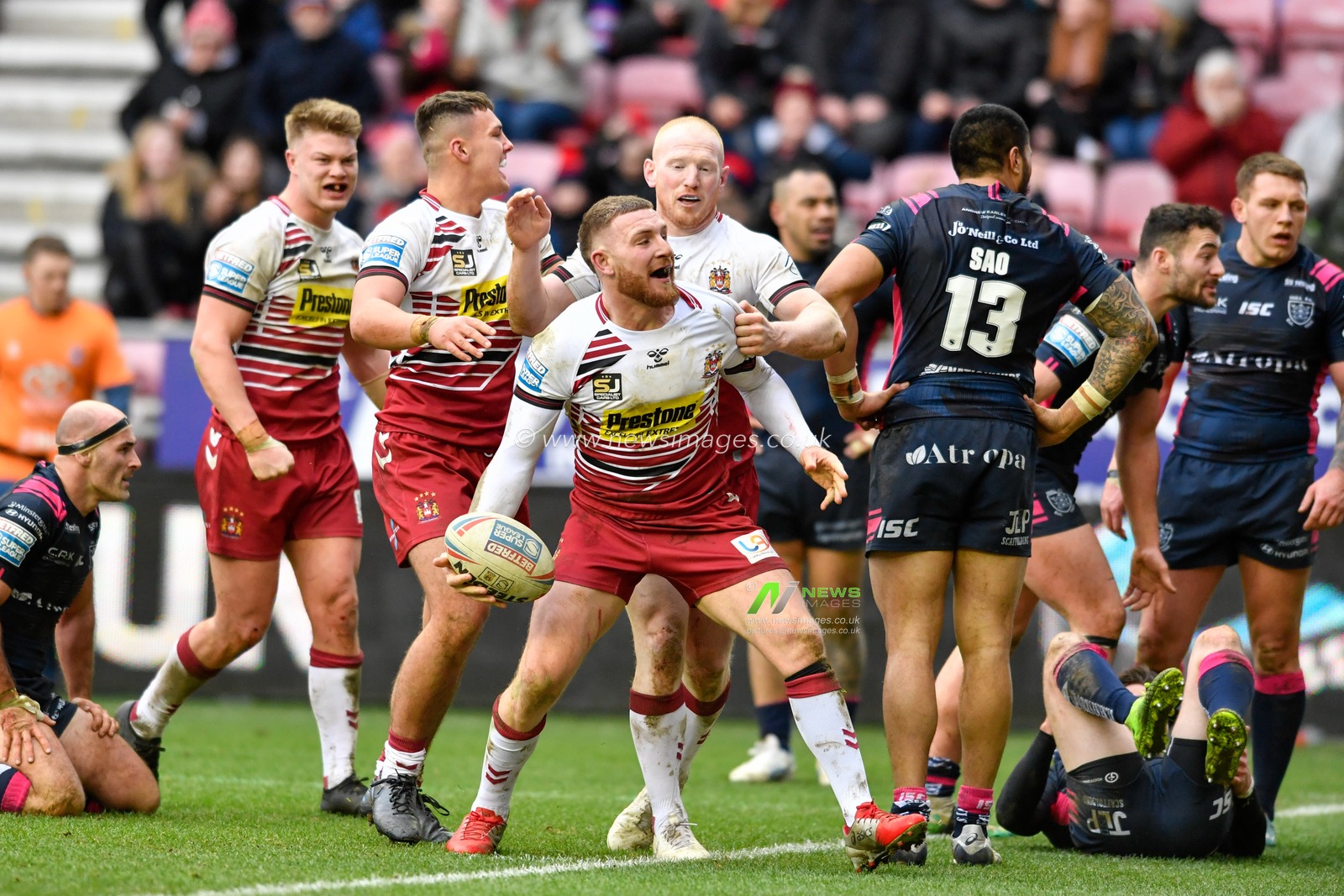 23rd February 2020, DW Stadium, Wigan, England; Betfred Super League, Wigan Warriors v Hull FC : Jackson Hastings (31) of Wigan Warriors celebrates scoring a try with his team mates