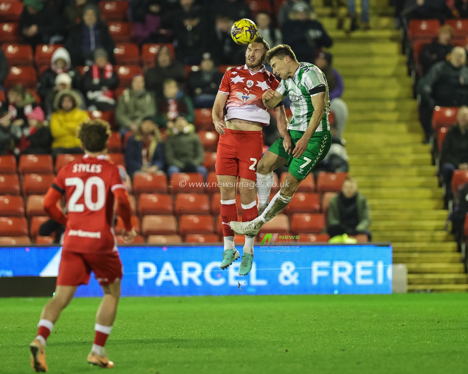 Jamie McCart #26 of Barnsley jumps up to win the high ball from David Wheeler #7 of Wycombe Wanderers during the Sky Bet League 1 match Barnsley vs Wycombe Wanderers at Oakwell, Barnsley, United Kingdom, 28th November 2023

(Photo by Mark Cosgrove/News Images)
