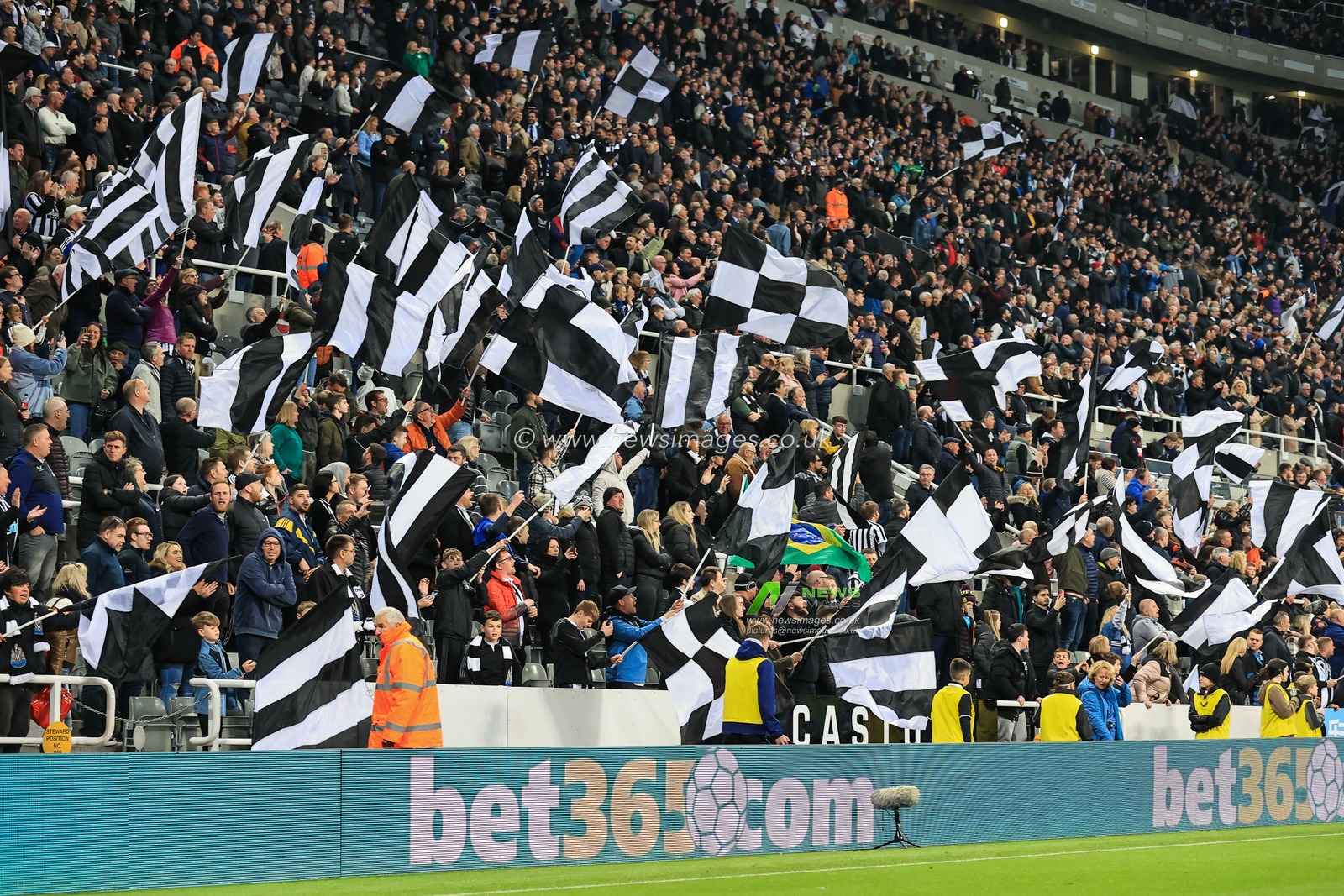 Newcastle United fans wave flags and celebrate as Newcastle United win 1- 0