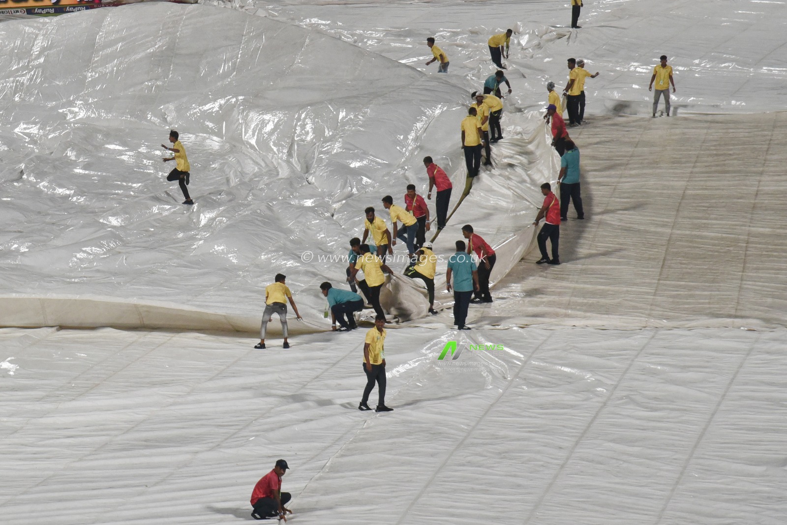 The ground staff work to keep the pitch dry as play is tries to stop the ball due to rain during the 2025 IPL match between Kolkata Knight Riders and Punjab Kings at Eden Gardens on April 26, 2025, in Kolkata, India. Photo by Debajyoti Chakraborty.(Photo: Debajyoti Chakraborty/News Images)