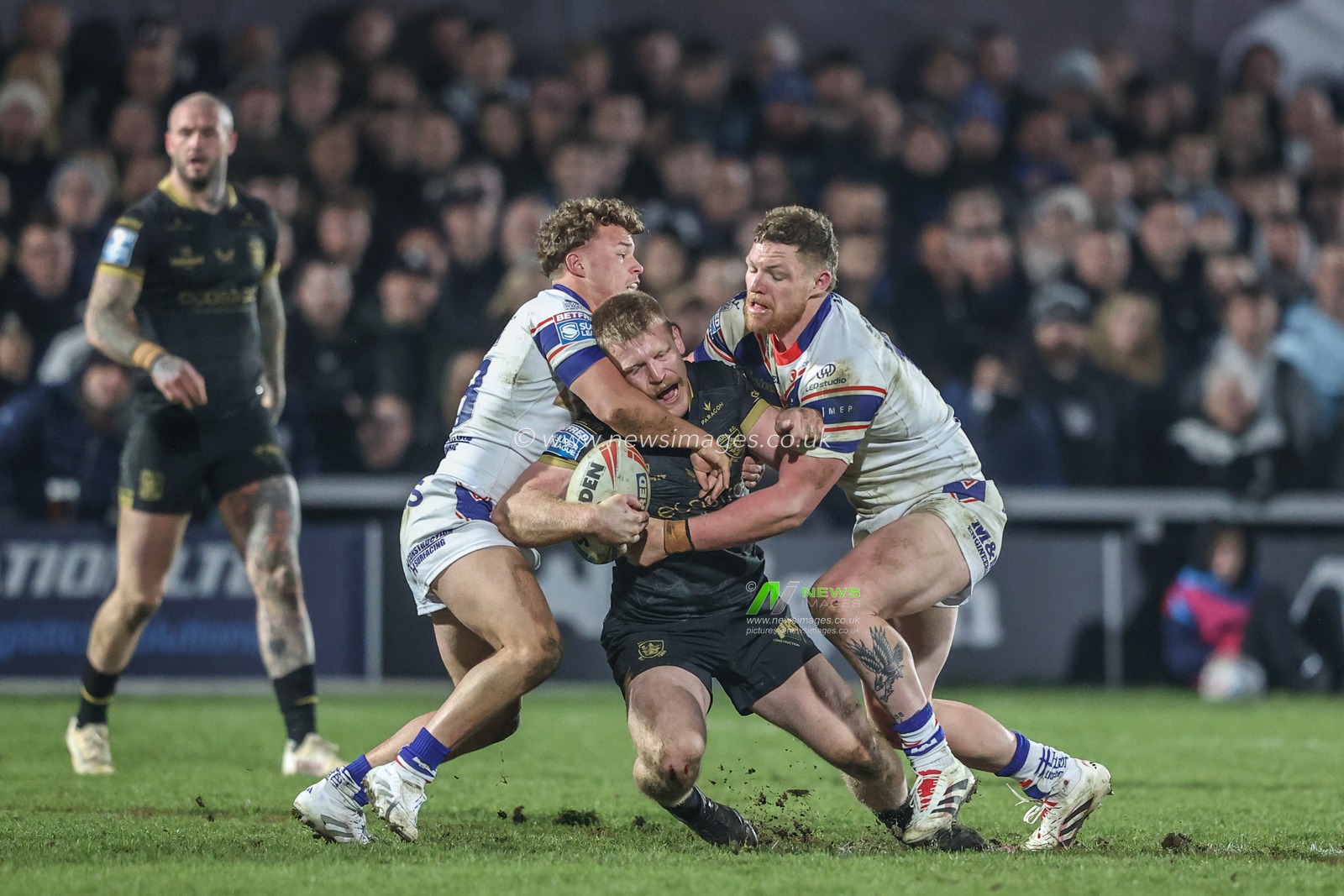 Brad Fash of Hull FC is tackled by Harvey Smith of Wakefield Trinity and Ky Rodwell of Wakefield Trinity during the Betfred Super League Round 5 match Wakefield Trinity vs Hull FC at DIY Kitchens Stadium, Wakefield, United Kingdom, 21st March 2025

(Photo by Alfie Cosgrove/News Images)