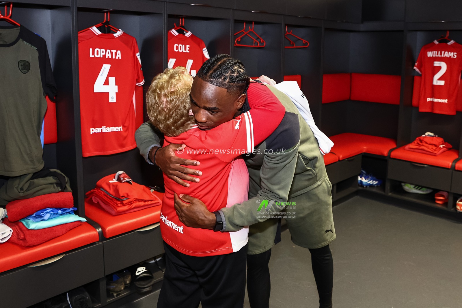 Devante Cole #44 of Barnsley presents Joan Desbro with an away shirt with â€œDesbro 90â€ on the back as she makes Barnsley FC club history as she becomes the clubs oldest mascot on there 90th birthday during the Sky Bet League 1 match Barnsley vs Charlton Athletic at Oakwell, Barnsley, United Kingdom, 16th December 2023

(Photo by Mark Cosgrove/News Images)