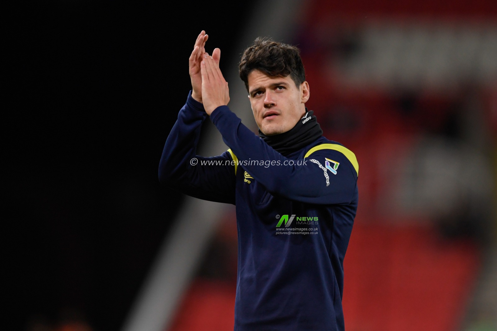 Christian Norgaard #6 of Brentford applauds the travelling supporters before the game