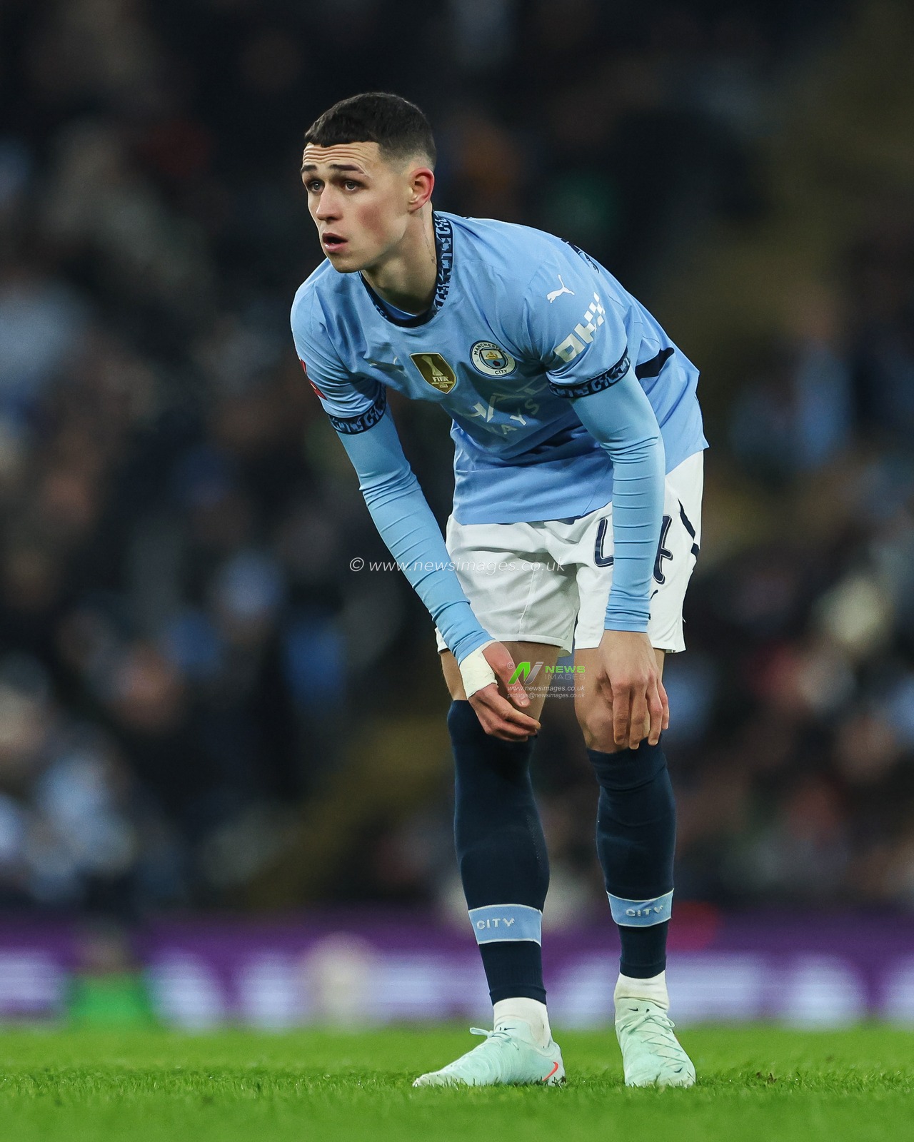 Phil Foden of Manchester City pulls his socks up during the Emirates FA Cup 3rd Round match Manchester City vs Salford City at Etihad Stadium, Manchester, United Kingdom, 11th January 2025

(Photo by Mark Cosgrove/News Images)