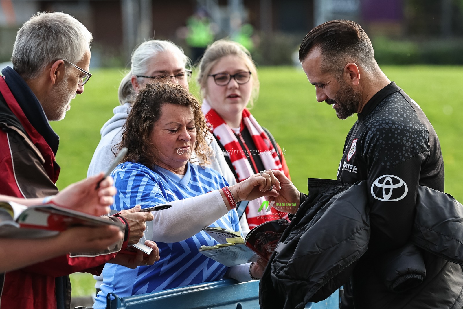 Martin Devaney caretaker manager of Barnsley signs fans books during the Sky Bet League 1 Play-offs Semi-final second leg match Bolton Wanderers vs Barnsley at Toughsheet Community Stadium, Bolton, United Kingdom, 7th May 2024

(Photo by Mark Cosgrove/News Images)