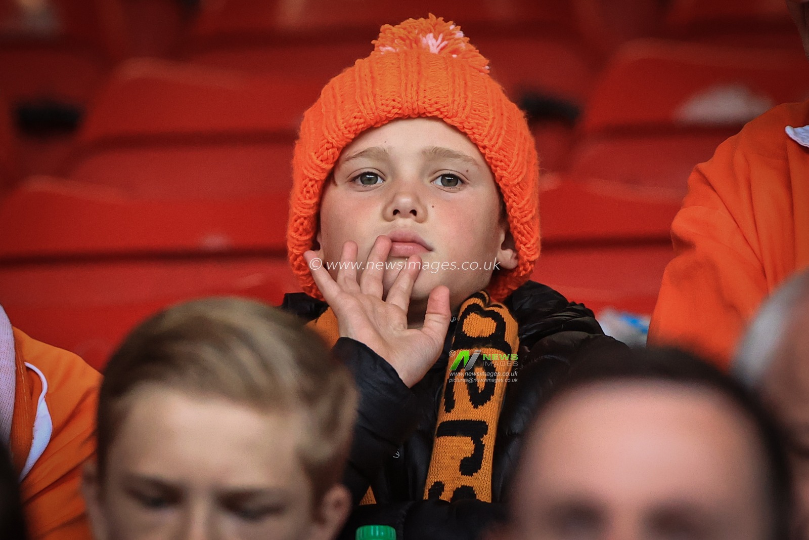 A young Blackpool fan waves during the pre-game warmup