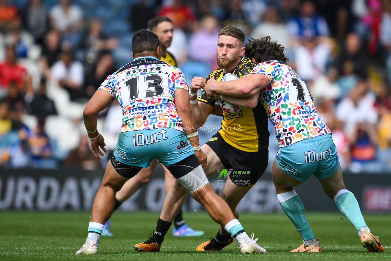 Ethan Ryan of Salford Red Devils is tackled by John Asiata of Leigh Leopards and Robbie Mulhern of Leigh Leopards during the Magic Weekend match Leigh Leopards vs Salford Red Devils at Elland Road, Leeds, United Kingdom, 18th August 2024

(Photo by Craig Thomas/News Images)