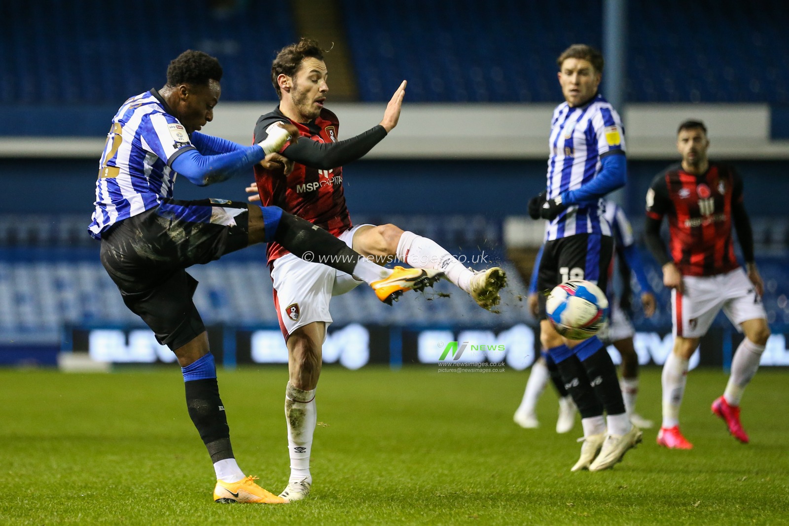 Moses Odubajo (22) of Sheffield Wednesday is tackled by Adam Smith (15) of Bournemouth