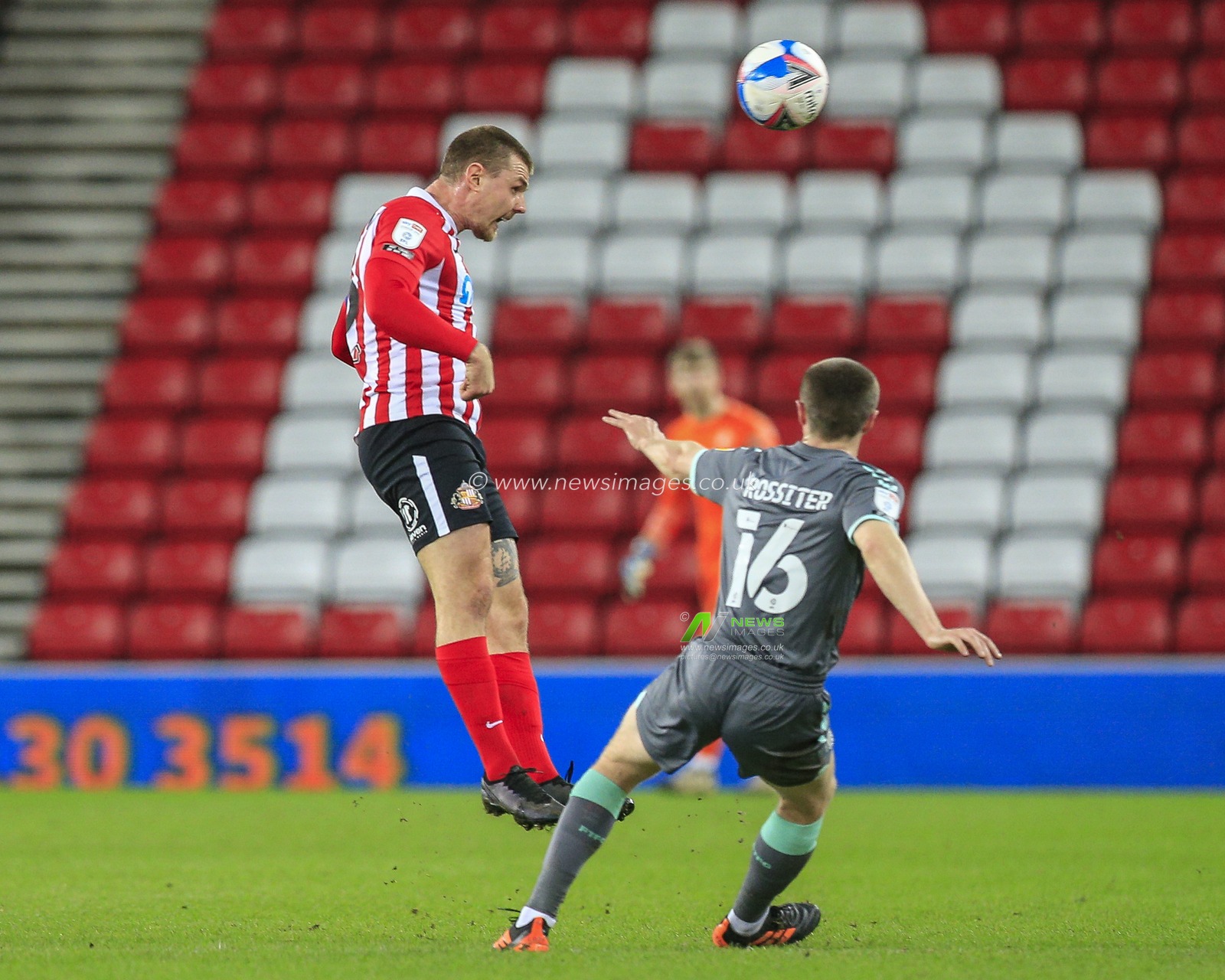 Max Power #6 of Sunderland heads the ball with Jordan Rossiter #16 of Fleetwood Town nearby