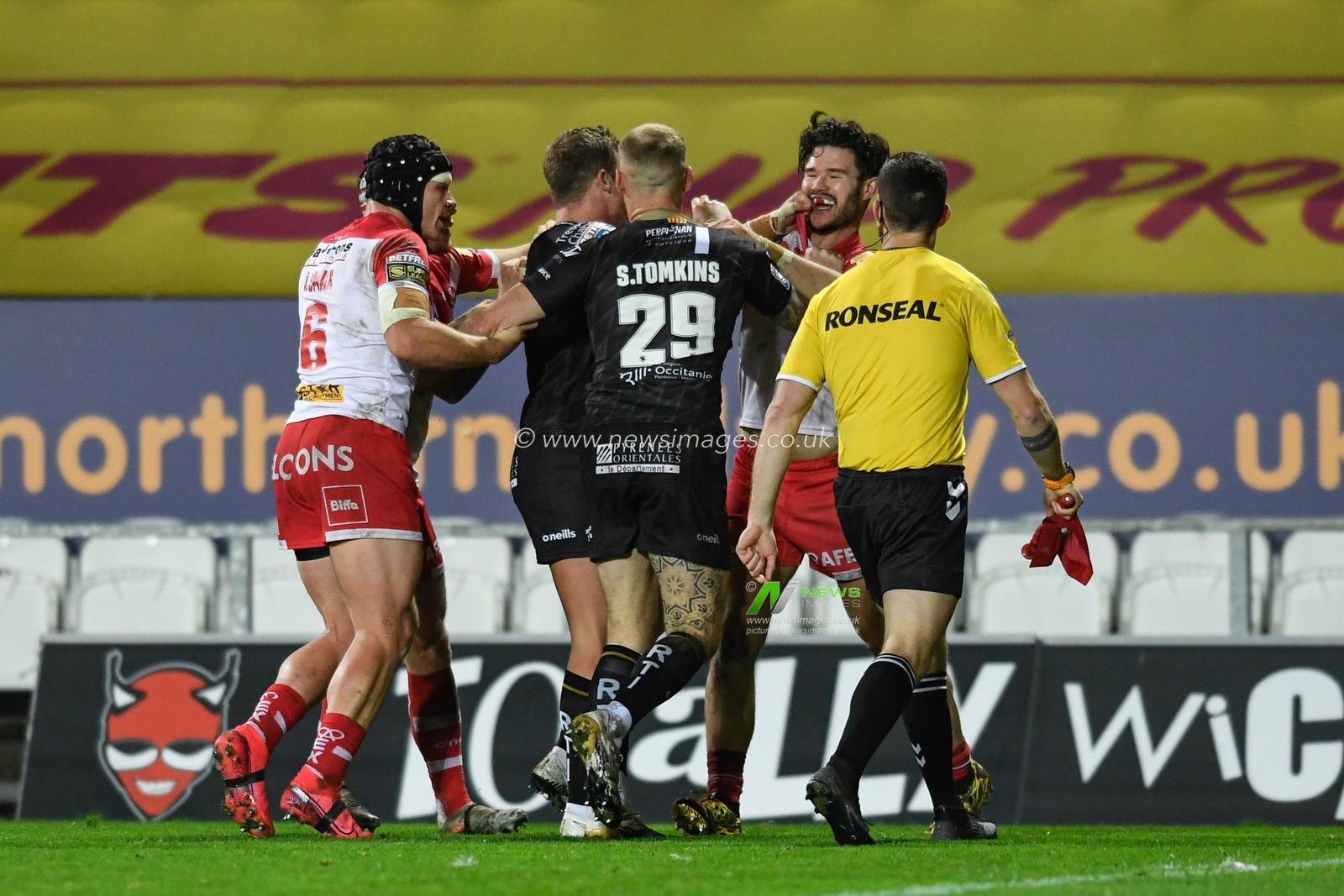 Josh Drinkwater #7 of Catalans Dragons and James Bentley #20 of St Helens have an on field disagreement