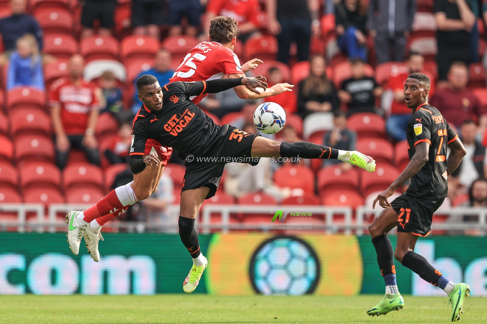 Dujon Sterling #35 of Blackpool and Matt Crooks #25 of Middlesbrough tangle in mid-aIr