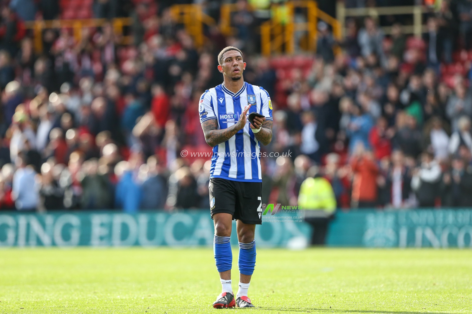 Liam Palmer #2 of Sheffield Wednesday acknowledges the travelling support during the Sky Bet League 1 match Lincoln City vs Sheffield Wednesday at Gelder Group Sincil Bank Stadium, Lincoln, United Kingdom, 22nd October 2022

(Photo by Arron Gent/News Images)