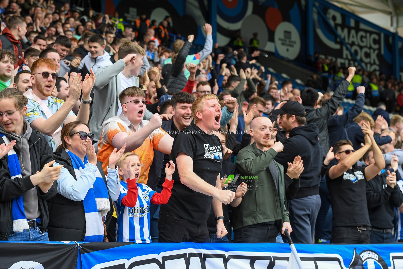 The Huddersfield Town fans celebrate their team scoring a goal to make it 1-0