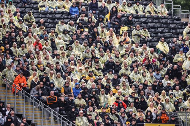 Wolves fans with waterproof coats on as it begins to rain heavily during the Premier League match Wolverhampton Wanderers vs Leeds United at Molineux, Wolverhampton, United Kingdom, 20th September 2025

(Photo by Alfie Cosgrove/News Images)