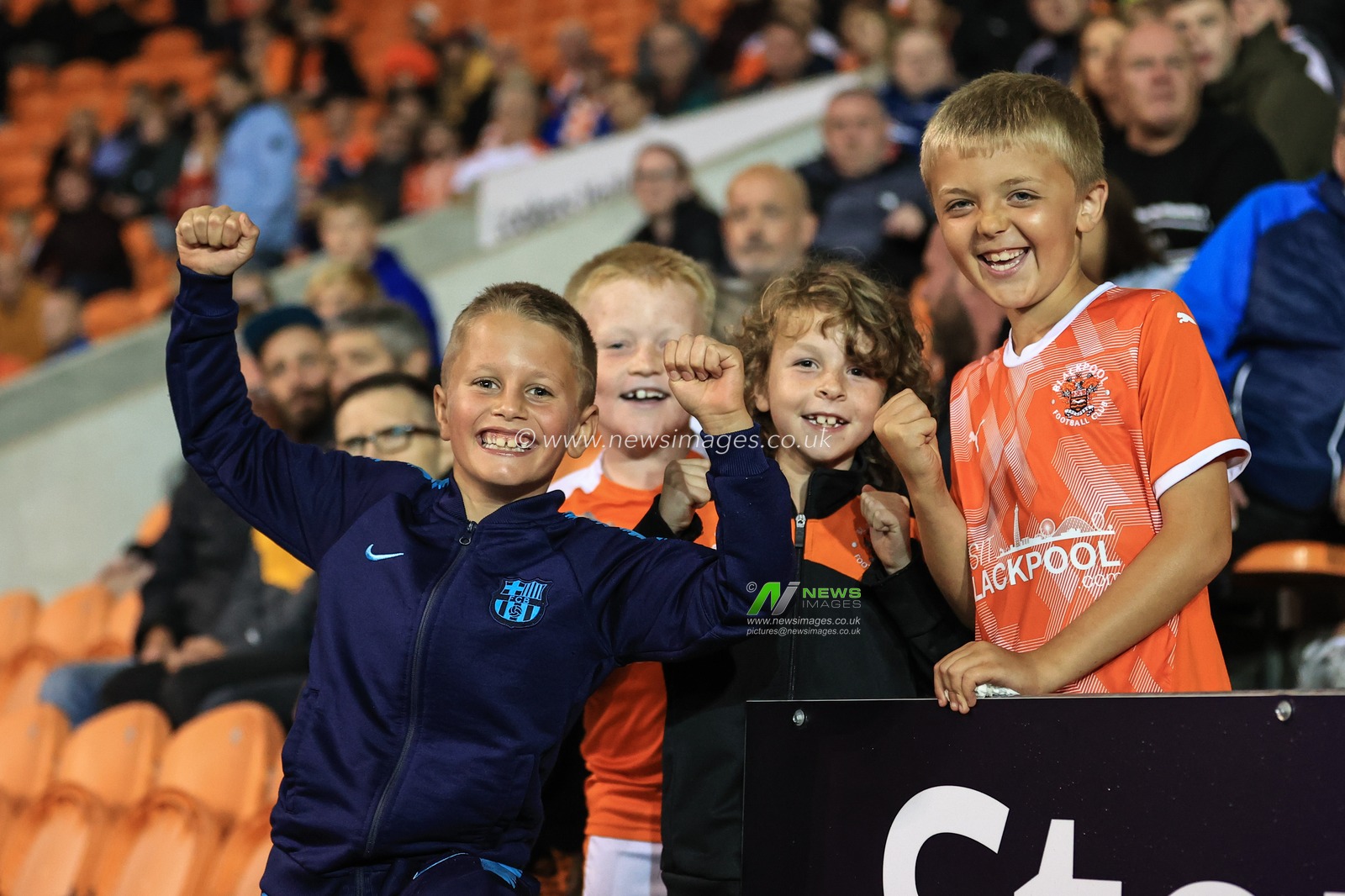 Four young Blackpool fans celebrate their 3-0 win