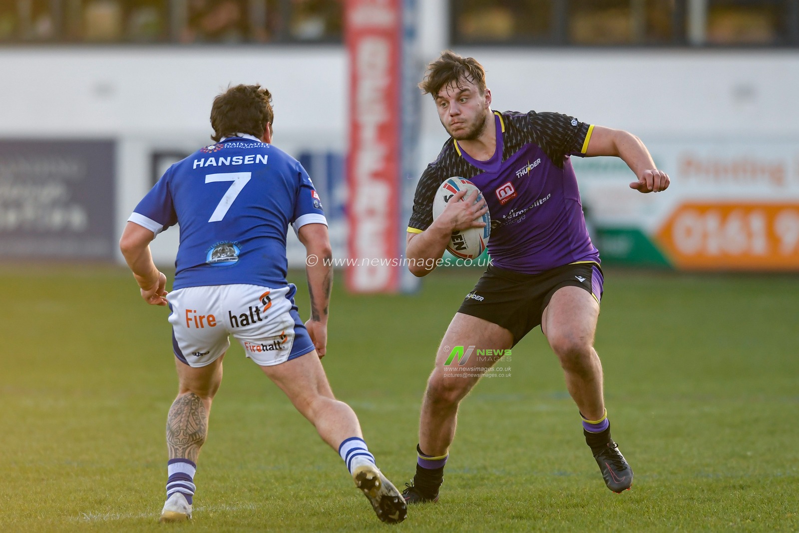 Sam Wilde (12) of Newcastle Thunder looks for a way past Jack Hansen (7) of Swinton Lions