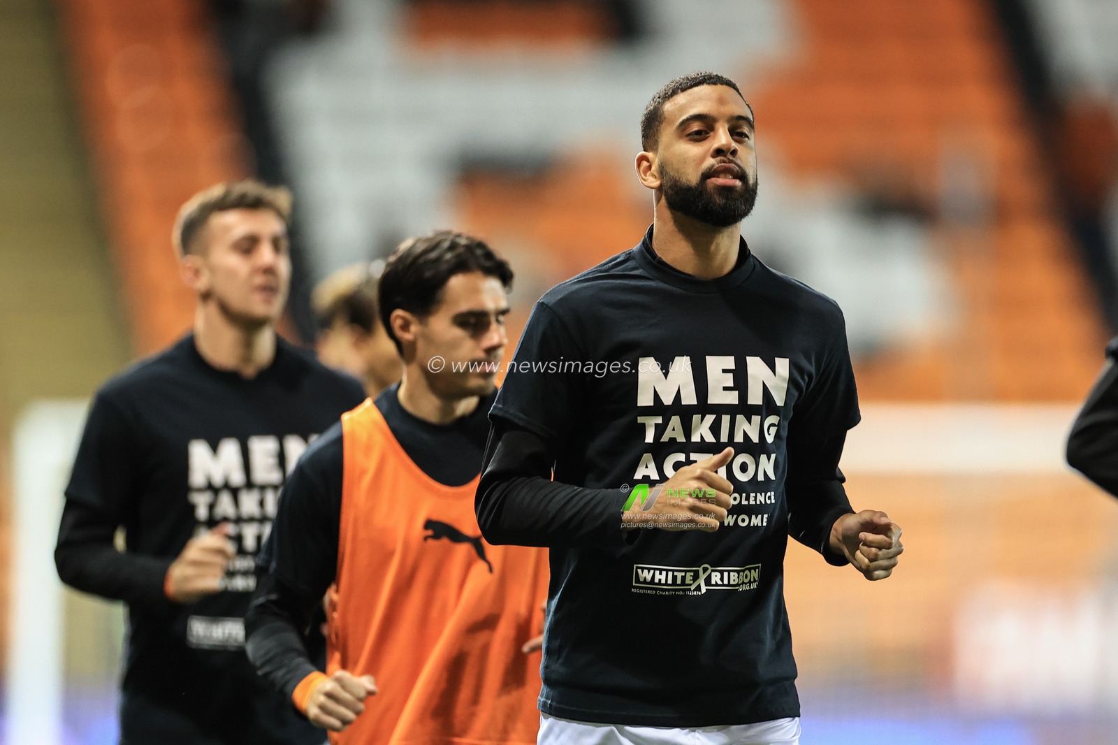Cj Hamilton #22 of Blackpool wearing a t-shirt supporting â€˜Men Taking action against violence towards womenâ€™ during the pre-game warmup